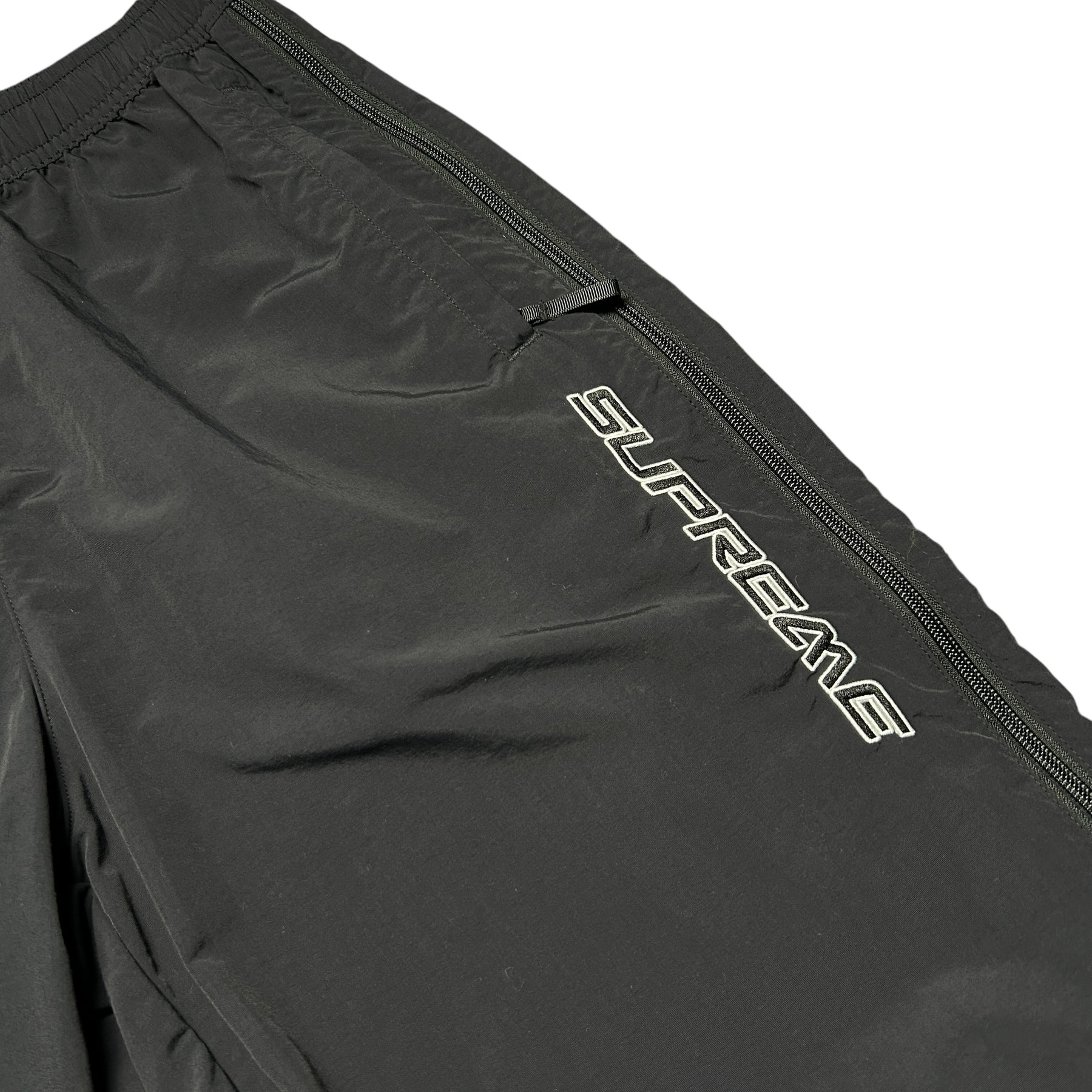 SUPREME WOVEN TRACK BOTTOMS
