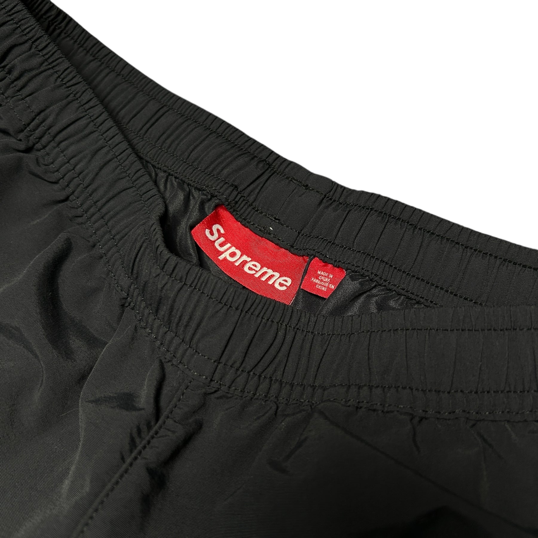 SUPREME WOVEN TRACK BOTTOMS